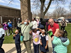Students and staff looking at the Eclipse